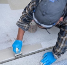 man applying concrete finish.