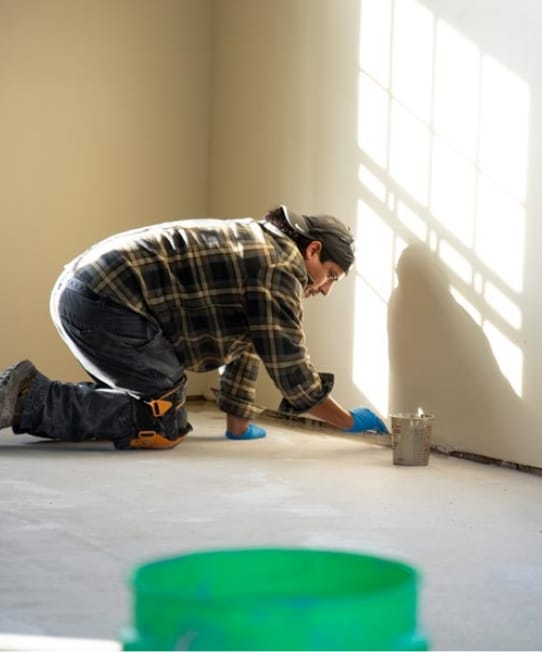 Man installing concrete coatings flooring.